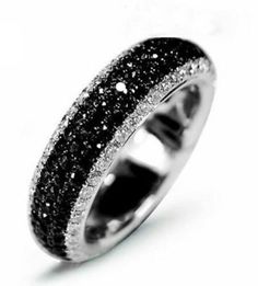 a black and white ring with sparkles on it