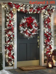 the front door is decorated for christmas with red and white wreaths, lights, and decorations