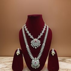 This stunning emerald AD necklace set is a must-have accessory for Indian brides. The exquisite design features sparkling CZ imitations of diamonds, adding elegance and sophistication to any bridal look. Perfect for traditional weddings and other special events, this necklace set is sure to turn heads and make a lasting impression. Earring Closure: pushback. All International Shipments of our Jewelry is dispatched through either FedEx or DHL and are delivered to your doorstep. Note: The product may be a slightly different shade from the picture because of picture editing. Please ask all questions regarding the color, size, measurements, etc before you buy Silver Crystal Sets For Wedding, Silver Crystal Wedding Sets, Festive Crystal Jewelry Sets For Wedding, Silver Crystal Gift Sets, Silver Diamond Sets As Gift, Traditional Crystal Bridal Sets For Festive Occasions, Festive Silver Diamond Bridal Sets, Festive Silver Bridal Sets For Anniversary, Silver Wedding Sets With Elegant Design