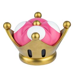 a pink and white object sitting on top of a gold stand with two balls in it