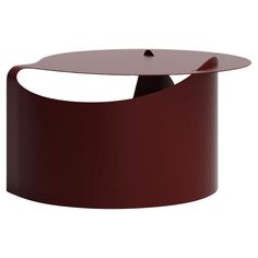 a round table with an oval top and curved base, in dark brown color on white background