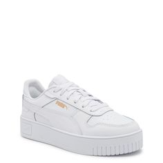 Make your athleisure wear stand out with these women's Puma Carina street white/white gold fashion athletic shoes. Featuring leather and synthetic leather upper with recycled materials, these lace-up sneakers have soft textile lining, SoftFoam+ sockliner offering optimal cushioning and comfort, supportive rubber midsole and durable rubber outsole. | Puma Women's Carina Street Sneaker in White Gold Leather Size 8. 5 Medium Puma Shoes Women Outfit, Essential Shoes For Women, Europe Shoes, White Pumas, Girly Sneakers, Puma White Sneakers, Fashion Athletic Shoes, Puma Shoes Women, White Puma Sneakers