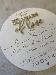 a wedding cake topper with the words 50 years and love written in cursive writing