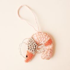 an ornament made to look like a fish with beads on it's head