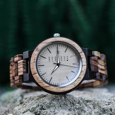 This wood watch is made out of two-toned zebrano wood, and has a date and week display. This men's watch can be custom engraved, making it a personalized and original gift. Because wood is a natural material, it is super comfortable and lightweight to wear. All of our wood watches are unique and one of a kind. Our wooden watches can be personalized by having the back case engraved. Our watches come in a luxury wooden giftbox and are a great gift for men. 🤗 FREE ENGRAVING 🤗 It is possible to pe Round Watches With Date Display As Gift, Gift Watches With Date Display, Timeless Watches With Date Display As A Gift, Stainless Steel Chronograph Watch As Gift, Timeless Gift Watches With Date Display, Timeless Watch With Date Display As Gift, Stainless Steel Chronograph Watch Gift, Stainless Steel Chronograph Watch With Round Dial For Gifts, Personalized Stainless Steel Watches With Round Dial