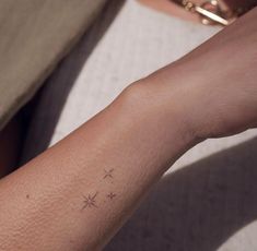 a person with a small star tattoo on their arm