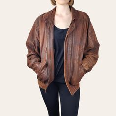 Introducing this unique 1980s vintage distressed leather Bomber Jacket in a rustic brown!  Perfect for those with a love for vintage fashion, this leather jacket exudes cool, retro vibes. The distressed look design adds a touch of edginess, while the brown leather gives it a classic look. Stand out from the crowd in this one-of-a-kind piece that combines style and nostalgia effortlessly. Add this statement jacket to your collection and rock a timeless look with a modern twist. DRY CLEANED since Vintage Brown Rugged Leather Jacket For Fall, Vintage Distressed Outerwear For Fall, Rugged Brown Leather Jacket, Distressed Brown Leather Jacket With Long Sleeves, Brown Distressed Leather Jacket With Long Sleeves, Vintage Distressed Leather Outerwear, Distressed Rugged Brown Outerwear, Rugged Distressed Brown Outerwear, Vintage Brown Distressed Outerwear