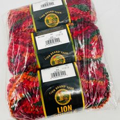 three bags of lion brand yarn sitting on top of each other