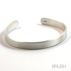 A substantial mens silver bracelet, 8mm wide and 2mm thick. The size and weight of this material make the bracelet very strong. This sterling silver cuff bracelet was designed for men but suits both men and women.The ends of the cuff are rounded for comfort. This cuff is available with three finishes - satin, shiny and oxidised. They are all shown in the photos.PERSONALISATION: Please contact me by convo if you would like to arrange personalisation (stamping or engraving) as there is an addition Mens Silver Cuff Bracelet, Mens Sterling Silver Bracelets, Iconic Outfits, Engraved Cuff, Silver Jewelry Diy, Handmade Silver Jewellery, Mens Bracelet Silver, Fine Silver Jewelry, Bracelet Mens