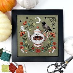 a cross stitch pattern with scissors, yarn and pumpkins