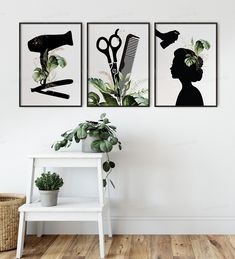 three black and white paintings on the wall above a table with a potted plant