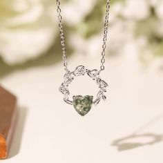 Cue the romance with our stunning Heart’s Desire Moss Agate Necklace. This perfect expression of true love features a natural charm of a wreath-like pendant with a heart-shaped moss agate gem at the center. A cherished keepsake that radiates love from every angle. ✦ 14K White Gold Vermeil (14K white gold plated over a sterling silver base) Wedding Open Heart Gemstone Necklace, Wedding Necklaces With Round Natural Stone Pendant, Elegant Heart Shaped Natural Stone Jewelry, Elegant Heart-shaped Natural Stone Jewelry, Wedding Necklace With Round Pendant Of Natural Stones, Nature-inspired Necklace With Round Pendant For Anniversary, Diamond Jewelry With Natural Stones As Gift, Nature-inspired Round Pendant Necklace For Anniversary, Diamond Jewelry With Natural Stones For Gift