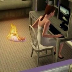 a woman sitting at a desk in front of a computer screen with a fire coming out of it