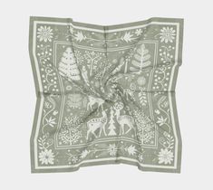 a green bandanna with deers and trees on it