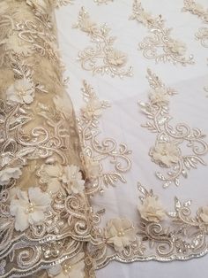 This Beautiful 3D Embroidered Satin Floral Pearl fabric is one of a kind. The fabric is backed with a mesh fabric and a gorgeous embroidered floral design, that gives off a 3D illusion. There are Pearls that have been stapled on to the fabric to give a gorgeous and eye catching design. Fabric is sold by the yard and if more than one yard is purchased, it will come in one piece. White satin is used for the backing of the fabric in images only, not included in the fabric. Width: 52" Uses: Apparel, Dresses (Prom, Formal, Wedding, Evening) , Accessories, Handbags, Table Skirts, and much more Content: 100% Polyester Champagne Dresses Formal, Pearl Fabric, Table Skirts, Illusion 3d, Evening Accessories, Table Skirt, 3d Illusion, Wedding Lace, Prom Formal