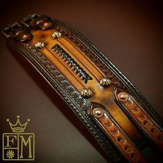 a brown leather belt with metal decorations on it