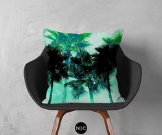 a chair with a pillow on it sitting in front of a white wall and palm trees