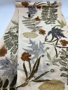 the fabric has been made with flowers and leaves on it, as well as other things