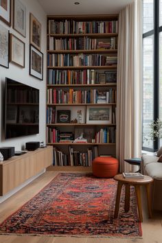 a living room filled with furniture and a large book shelf next to a flat screen tv