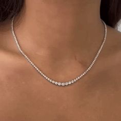 The Riviera Diamond Tennis Necklace is an exquisite piece of jewelry that combines elegance and timeless beauty. This necklace features a total carat weight of 4.00 ct., showcasing a dazzling array of diamonds. The diamonds used in this necklace range in size from 2.60 mm to 4.60 mm, creating a captivating visual effect with their varying sizes. The necklace is crafted with meticulous attention to detail and is set in a Buttercup Setting, which is known for its graceful and secure design. The Bu Diamond Tennis Necklace, 14k Yellow Gold Necklace, White Gold Necklaces, Tennis Necklace, Gold Jewellery Design, Jewelry Inspo, Dream Jewelry, Simple Necklace, White Diamonds