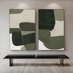 two abstract paintings hang on the wall above a bench