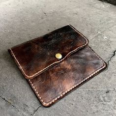 a brown leather wallet sitting on the ground