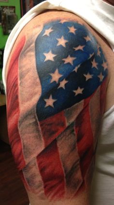 an american flag tattoo on the back of a man's arm