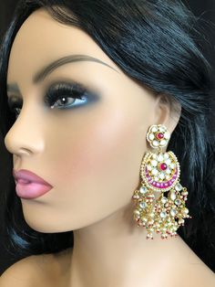 Beautiful and Unique Style Affordable Luxury traditional Bollywood Chandbali earrings with Kundan stones and Colored ruby semi precious Stones. 22k gold plated jewelry Length: 3.5 Inches Comes with push back closure Made in Brass with very high quality Kundan stones and Pearls. Lightweight Jewelry Click here to see the complete collection of Kundan and Polki Statement Earrings at AryaFashions: https://www.etsy.com/shop/AryaFashions?section_id=25872820 Follow us on social media for new and latest Kundan Chandbali, Ruby Bangles, Jewelry Kundan, Kundan Jewelry, Chandbali Earrings, Ruby Wedding, Light Weight Jewelry, Earrings Indian, Kundan Earrings