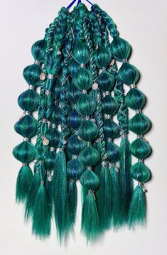 Dive into enchantment with my Deep Sea Mermaid Braids. These braids blend light and dark teal shades, mixed with multi-shade blue tinsel that's sparkly and iridescent. You'll shimmer like the ocean depths! Each elastic includes 6 braids adorned with silver cuffs and wrapped in sparkly silver cord. Iridescent sea shell and pearl charms add a touch of mermaid magic. Plus, there's an unbraided strand to wrap the base of your ponytail for a polished look. Handcrafted with love, these braids bring out your inner mermaid, making you the dazzling beacon of the sea at any festival or rave. Dive in and let your hair tell a story as magical as the ocean itself. Under The Sea Hairstyles, Dark Mermaid Hair, Mermaid Core Hair, 6 Braids, Deep Sea Mermaid, Mermaid Hairstyles, Dark Teal Hair, Mermaid Braids, Teal Shades