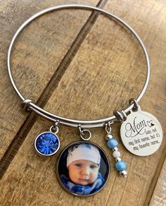 "Mom bracelets feature your favorite photo, Mom saying engraved in stainless steel, matching beads, and your choice of rhinestone color. Options to add more photos and rhinestones are available at checkout. These make great gifts!! INCLUDES: - Photo Charm - Saying as shown - Rhinestone (your choice of color) - Matching Beads Bracelets are made of stainless steel and come in 3 sizes: - Large 2.6\" (larger wrists/hands) - Average 2.4\" (fits most) - Child 2.0\" (elementary school age or tiny wrist Customizable Stainless Steel Jewelry For Mother's Day, Customizable Stainless Steel Jewelry For Personalized Gifts, Nickel-free Stainless Steel Jewelry For Keepsake, Personalized Metal Jewelry For Memorial, Personalized Stainless Steel Jewelry For Memorial, Customizable Blue Jewelry For Mother's Day, Adjustable Stainless Steel Keepsake Jewelry, Customized Stainless Steel Jewelry For Memorials, Customized Stainless Steel Jewelry For Memorial