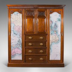 an antique wooden armoire with maps on it