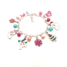 This adorable charm bracelet features an assortment of pink, green and white Christmas charms and an assortment of pink, green and white acrylic beads on a silver tone cable chain bracelet with lobster claw clasp. The bracelet is 8 inches long but the clasp allows you to clip onto any link to fit a wide range of wrist sizes. Your bracelet will arrive in an organza bag making it ready to give as a gift.   Please message me if you have any questions. Green And White Christmas, Cardboard Jewelry Boxes, Rhinestone Tiara, Christmas Bracelet, Small Jewelry Box, Christmas Charms, Holiday Jewelry, Pink Rhinestones, White Acrylic