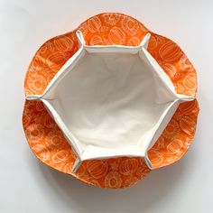 an orange and white plate sitting on top of a table