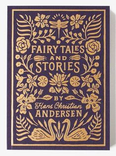 a blue and gold book cover with floral designs on the front, in gold foil