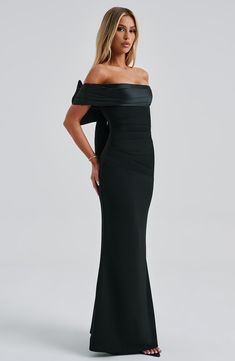 Introducing the dreamiest dress of the season, Joanna. This maxi style is cut from our luxe stretch crepe that hugs the figure and flares gently at the skirt. It has a pleated satin bardot panel neckline with stunning removable bow to the reverse. It's complete with pleats to the waist. 



Colour: Black.

Premium stretch crepe fabric.

Fully lined.

Pleated satin bardot panel on neckline.

Removable satin bow on reverse.

Asymmetric pleats on waist.

Fit and flare skirt.

Invisible zipper to the reverse.

Maxi length.

 Size: XS, S, M, L, XL, XXL Fit And Flare Skirt, Maxi Dress Sale, Maxi Styles, Dreamy Dress, Stretch Crepe, Black Maxi, Satin Bow, Formal Party, Crepe Fabric