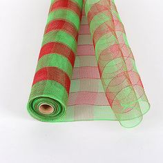 two rolls of green and red mesh sitting on top of each other in front of a white background