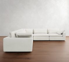 a white couch sitting on top of a wooden floor