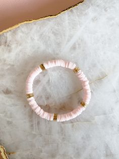 6mm Light Pink Heishi Beaded Bracelet with Solid Golden Brass Brushed Flat Disc Bead Spacers on Stretchy String. Please measure your wrist and select your size in the dropdown as this bracelet is not one size fits all. SIZING TIP: To find out your bracelet size, wrap a piece of string around your wrist to measure (place it just above the wrist bone.) Then measure the length of the string. Then I'd recommend adding 0.8 inches (2cm) to that measurement to get your correct bracelet size. Pink Rondelle Beaded Bracelets, Hand-strung, Pink Hand-strung Rondelle Beaded Bracelets, Pink Rondelle Beaded Bracelets, Stretch Bracelet With 8mm Heishi Beads, Pink Rondelle Beaded Bracelets For Gifts, Pink Rondelle Beaded Bracelets As Gift, Colorful Heishi Beads Bracelet, Initial Bracelet Gold, Beads Clay