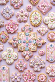 many decorated cookies are displayed on a table