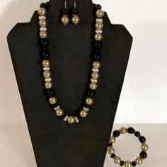 Hand Crafted Necklace, Bracelet, And Earrings New Pearl Necklace Set - 3 Pieces Black And Gold Beaded Necklace Set - Necklace Earrings Bracelet The Gold Beads Are Faux Pearls, The Black Beads Are Glass. The Spacers Are Glass And Metal. White With Gold Rim Spacers Wavy Metal Spacers Handmade 12mm Glass Beads 12mm Faux Pearls Necklace - 20” Drop Earrings- 1 3/8” Stretch Bracelet- 6.5” Statement This Set Is Elegant. Pair It With A Formal Gown, A Black Dress, A Suit Or A Pair Jeans. Casual And/Or Fo Classic Black Beaded Jewelry As Gift, Classic Gold Jewelry With Black Beads, Elegant Black Adjustable Jewelry Sets, Black Costume Jewelry Sets As A Gift, Black Costume Jewelry Sets For Gift, Black Round Beads Costume Jewelry, Adjustable Black Beaded Costume Jewelry, Elegant Black Beaded Jewelry Set, Black Round Beads Jewelry Set As Gift