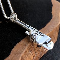 Men's Sterling Silver Pipe Wrench NecklaceThis unique men's jewelry piece is expertly handcrafted from solid sterling silver, ensuring both quality and durability. What sets it apart is its functional screw design, adding a touch of intrigue and playfulness. Embrace the industrial charm of this necklace, an expression of style and strength, making it the perfect choice for those who appreciate the extraordinary in every detail.Product DetailsMetal Type: 925 Sterling SilverGender: For MenStyle: PunkPendant Size: 14 mm (w) * 55 mm (h)Pendant Weight: 14.25 gChain Type: Sterling Silver Bead ChainChain Width: 2.5 mmLength: 18 in / 20 in / 22 in / 24 in / 26 in / 28 in / 30 in Silver Stainless Steel Jewelry With Custom Hardware, Silver Jewelry With Custom Hardware As Gift, Silver Jewelry With Custom Hardware Gift, Adjustable Jewelry With Custom Hardware For Gift, Silver Bracelets For Men, Pipe Wrench, Mens Silver Jewelry, Silver Chain For Men, Necklaces Silver