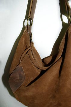 Handmade brown cognac suede medium size hobo bag The bag is closed with a metallic zip. Inside is unlined and there is a large cotton zipped pocket. The bag has an adjustable shoulder strap made with strong black leather. To add an extra touch to the bag you can buy the short handle which measures 18 inch in length and is made with beautiful black leather. This medium size hobo bag is a perfect bag for every moment Features : - Brown cognac suede, - Brown cognac leather strap, - Zipped bag, - Un Suede Hobo Bag With Zipper For Everyday Use, Suede Hobo Bag With Zipper For Daily Use, Suede Hobo Bag With Zipper Closure For Daily Use, Everyday Suede Hobo Bag With Zipper Closure, Chic Brown Hobo Bag With Zipper Pocket, Chic Brown Suede Hobo Bag, Suede Hobo Shoulder Bag With Zipper, Suede Hobo Shoulder Bag With Zipper Closure, Everyday Suede Shoulder Bag With Leather Trim