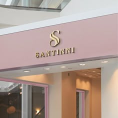 a pink and white store front with the name sanitini on it