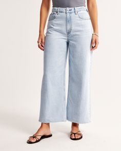 Our Curve Love high rise cropped wide leg jeans in a light wash with a raw-cut hem. This fit features a 10.5” high rise, is relaxed at the waist and hips, and eases into a wide, full-length leg shape with a cropped length. Our Curve Love styles add an additional 2” at the hip and thigh to allow room for your curves and eliminate waist gap. This jean is made from our super light drapey denim fabric, which features a super soft lightweight rigid denim. Light Wash Cropped Denim Bottoms, Cropped Medium Wash Bottoms With Frayed Hem, Spring Cropped Light Wash Pants, Spring Light Wash Pants With Frayed Hem, Spring Light Wash Cropped Pants, Light Wash Cropped Jeans For Summer, Light Wash Cropped Cotton Jeans, Cropped Light Wash Bottoms For Spring, Summer Light Wash Cropped Jeans