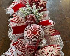 a red and white christmas tree with lollipops on it's side