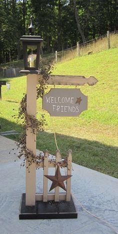 a wooden welcome sign with a star on it