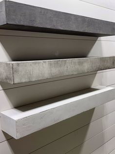 a white shelf sitting on the side of a building