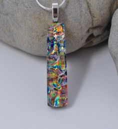 "I have fused 2 layers of dichroic glass with clear on top of the layers to achieve the effect in this pendant. The bottom layer of the dichroic is backed with black glass. The size of the pendant is 1 3/4 inch by 7/16 inch. I do not include the bail in this measurement, just the glass. The pendant is set with a sterling silver plated jewelry finding. The pendant will come with a 18\" sterling silver plated snake chain with a lobster claw clasp. It will also be in a cotton lined gift box. The co Fancy Garden Party, Fancy Garden, Fused Glass Jewelry Dichroic, Fused Jewelry, Dichroic Glass Jewelry, Dichroic Pendant, Fused Glass Artwork, Dichroic Glass Pendant, Glass Fusion