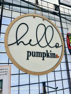 a sign hanging from the side of a building that says, rell o pumpkin