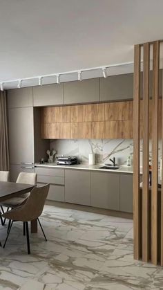 a modern kitchen with marble flooring and wooden cabinets